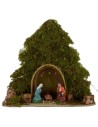 Tree with hut and Nativity illuminated with piled with