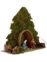 Tree with hut and Nativity illuminated with piled with