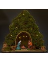 Tree with hut and Nativity illuminated with piled with