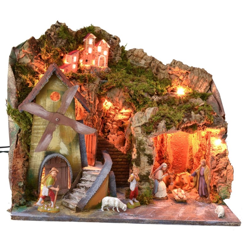 Classic illuminated nativity scene with grotto and mill running