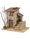 Casita de piedra con escalera lateral de 19x17x18 cm de altura.