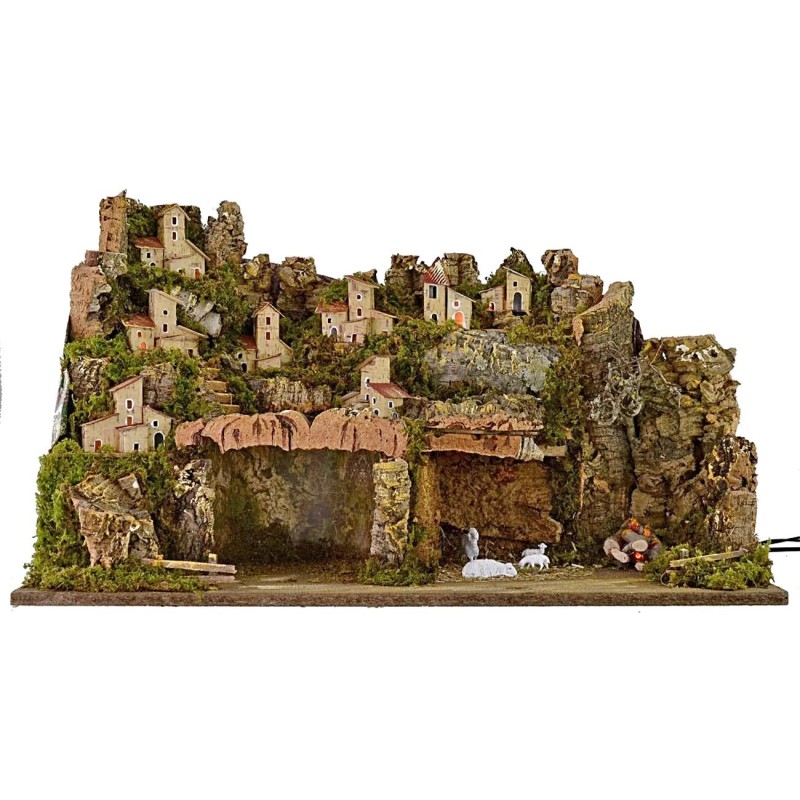 Illuminated nativity scene with working fire, village and cave