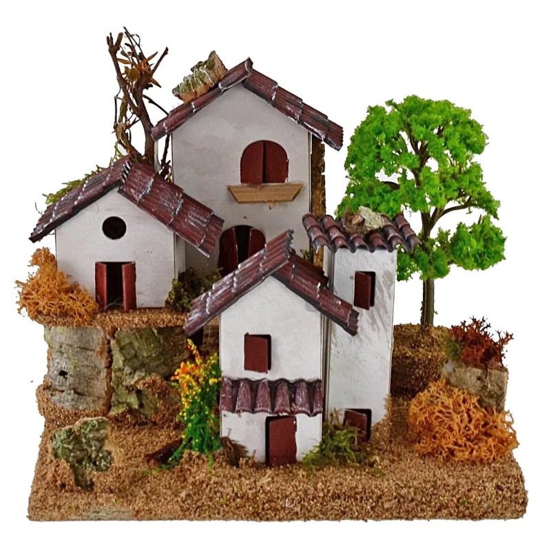 Casitas para belén en dos niveles con árbol de 15x19x14 cm de altura.