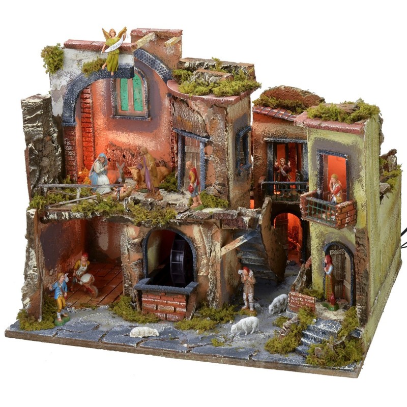 Nativity scene complete with statues with illuminated village, oven and