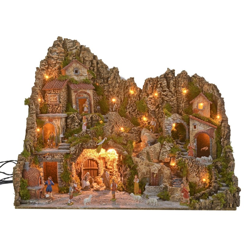 Illuminated nativity scene with cave, fountain, waterfall and fire