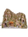 Illuminated nativity scene with cave, fountain, waterfall and fire