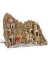 Illuminated nativity scene with cave, fountain, waterfall and fire