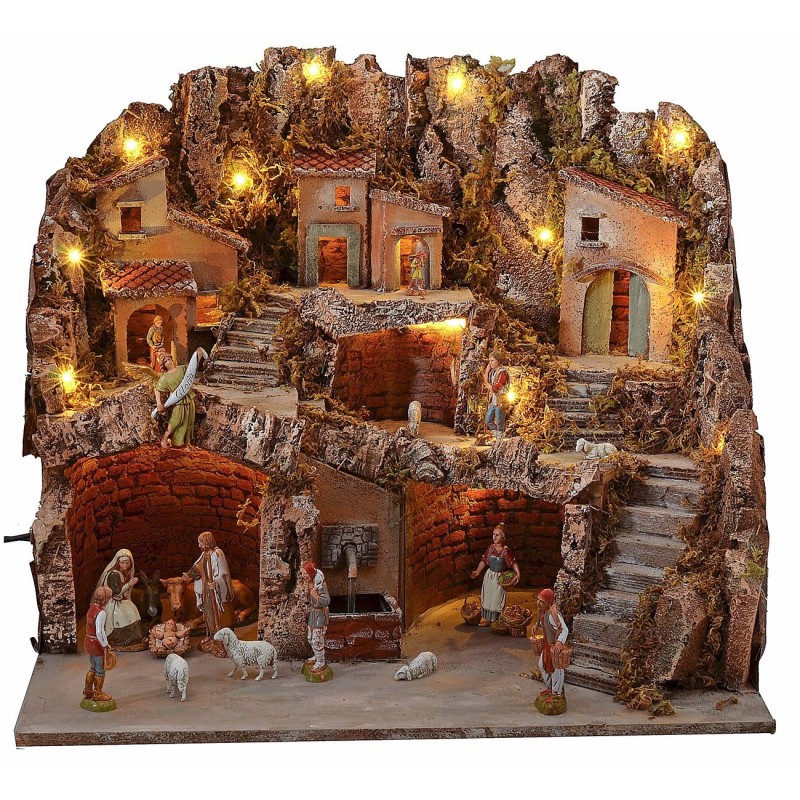 Illuminated nativity scene with caves and working fountain