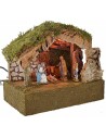 Illuminated hut with Nativity and moving bagpipe player cm