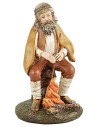 Shepherd with staff sitting in front of the fire in painted resin