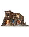 Illuminated nativity scene complete with statues, waterfall, fountain, and