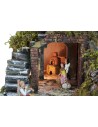 Illuminated nativity scene complete with statues, waterfall, fountain, and