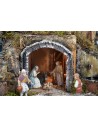 Illuminated nativity scene complete with statues, waterfall, fountain, and