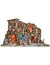 Illuminated nativity scene complete with statues, waterfall, fountain, and